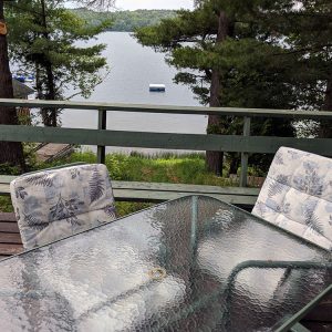 outdoor deck with patio set and lake view