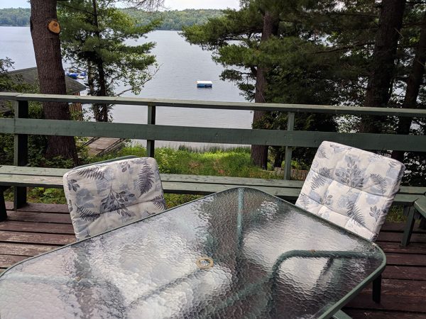 outdoor deck with patio set and lake view